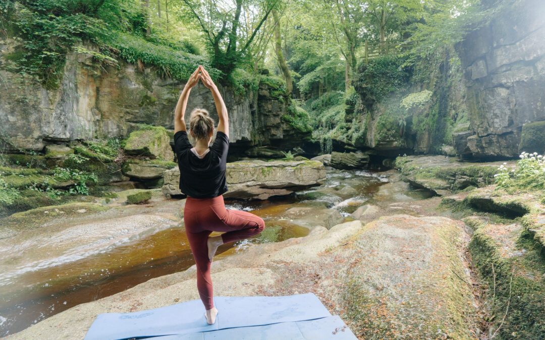 A woman in a yoga pose at How Stean Gorge, North Yorkshire