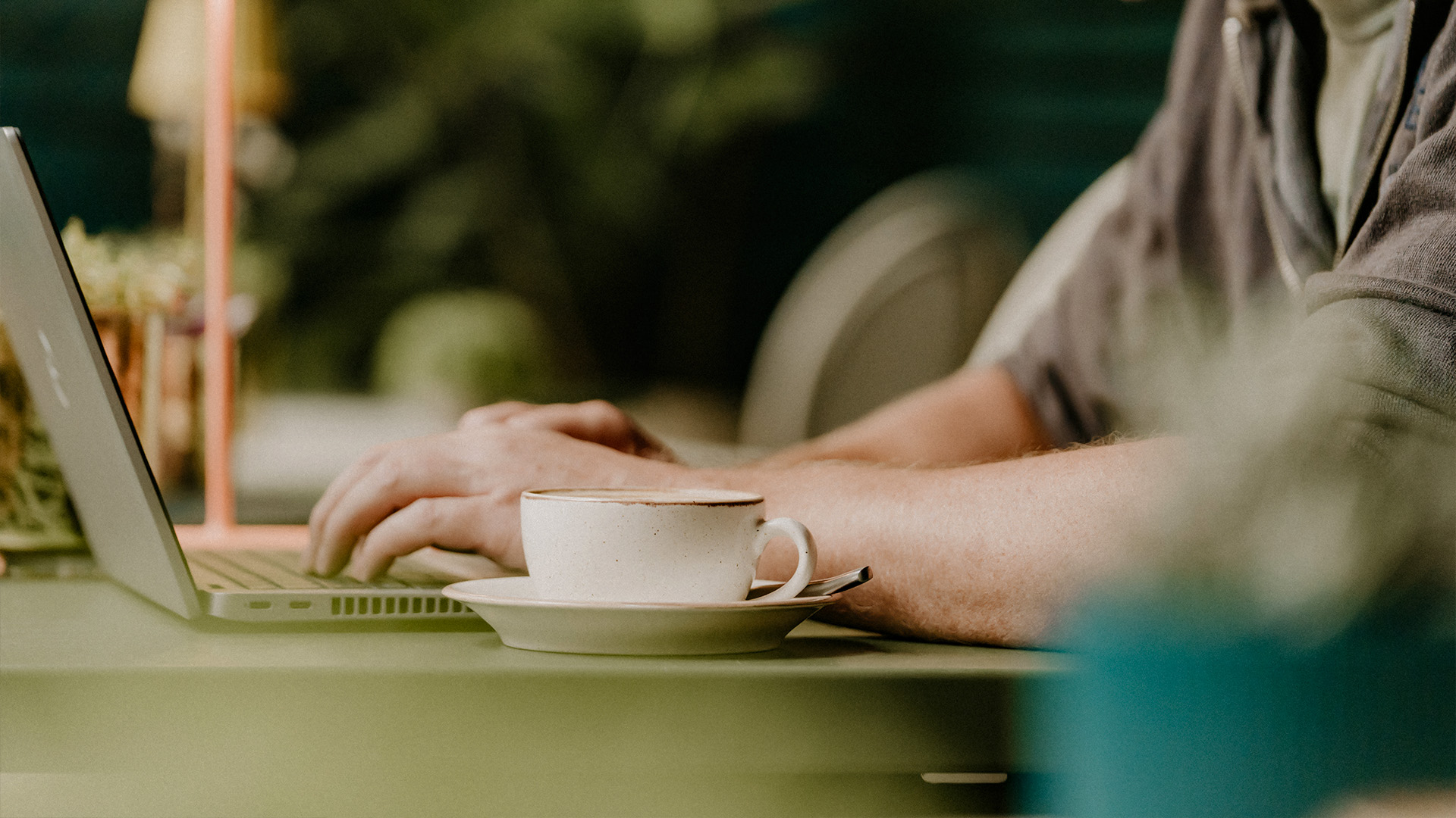 Someone browsing a website while enjoying a coffee